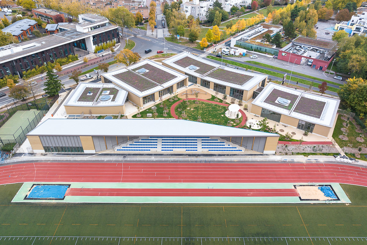The children's and sports centre building complex by HEMAA Architectes blends harmoniously into the surrounding topography and landscape. &copy; Sergio Grazia 