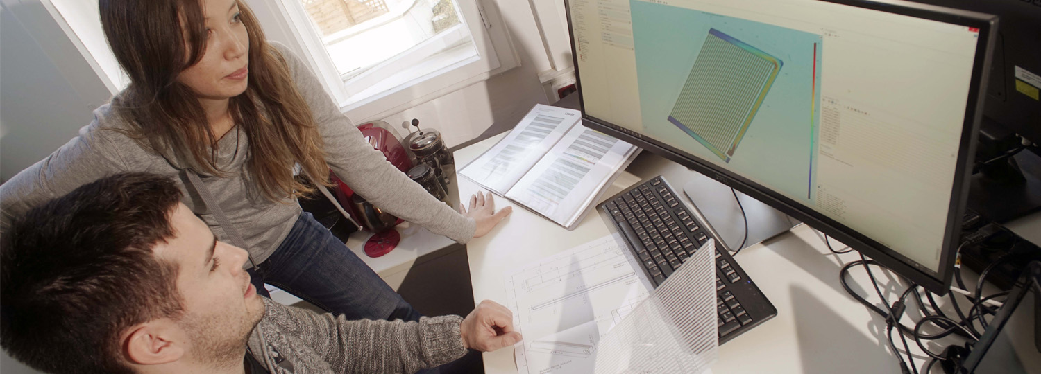 Die Doktoranden Mariana Fatobene Ando und Benjamin Heiz der FSU Jena untersuchen den Prototyp eines Glasmoduls; Foto: Jan-Peter Kasper