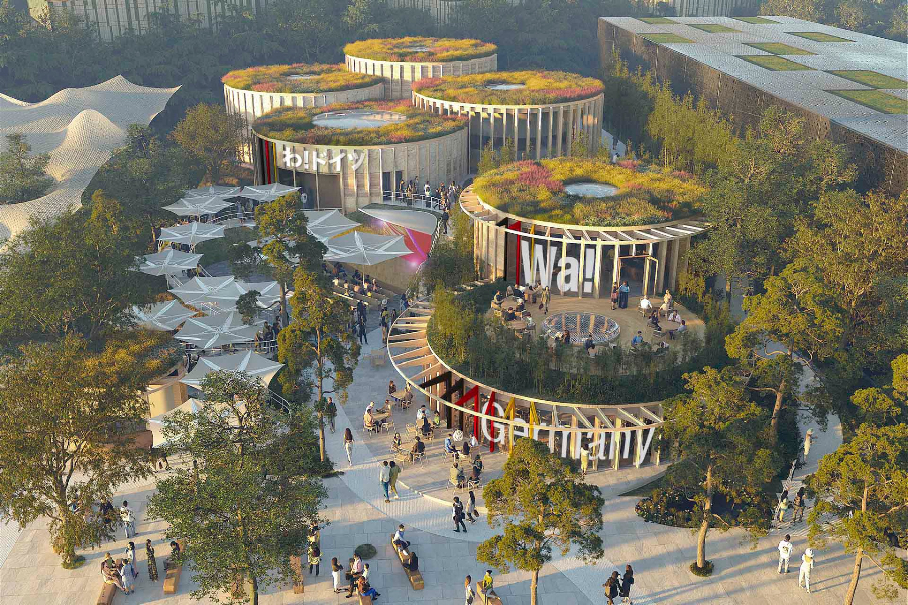 Modern exhibition space with numerous light objects, large screen wall and several visitors.