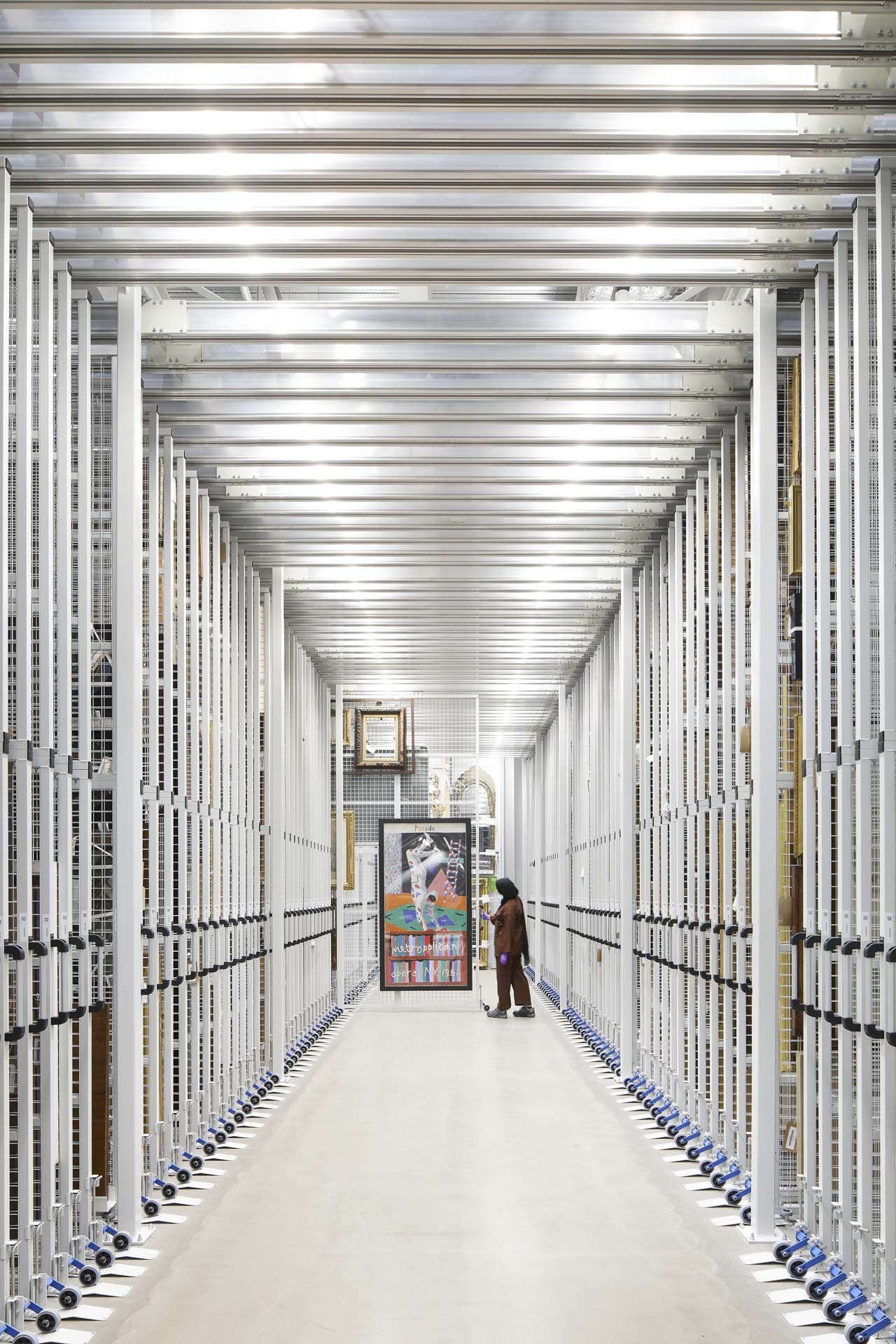 Corridor with metal shelves and pull-out walls for storing art prints.