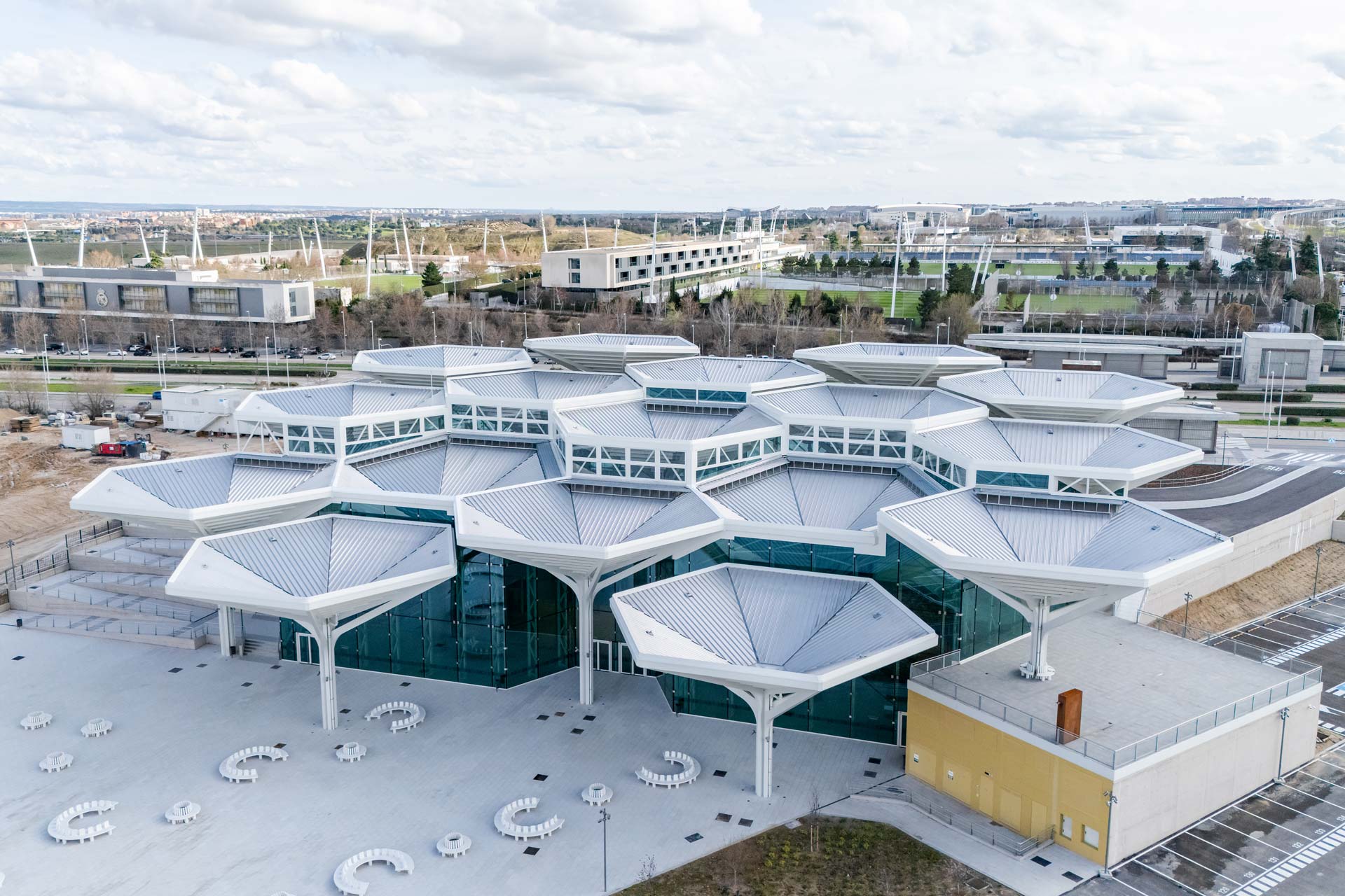 Roof landscape with grey hexagonal elements in an urban neighbourhood.