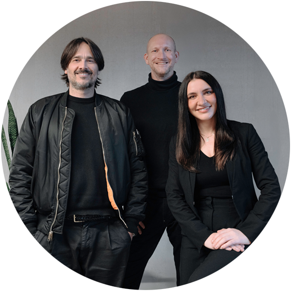 Two men and a women smiling into the camera.