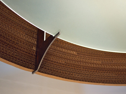 Graypants: Scraplight 'Drum' The luminaire 'Drum' by graypants consists of a robust steel frame covered with hand-made strips of cardboard.